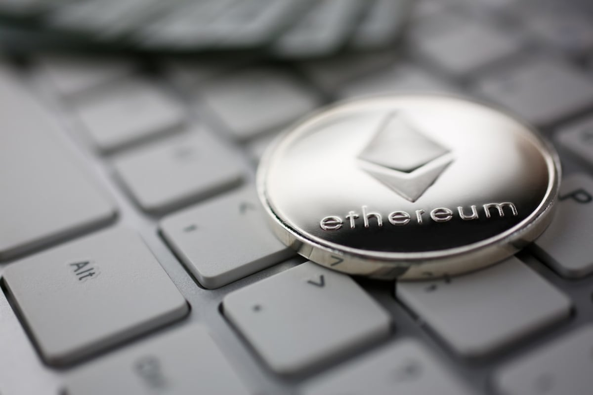 Close-up of an Ethereun cryptocurrency token sitting on a keyboard