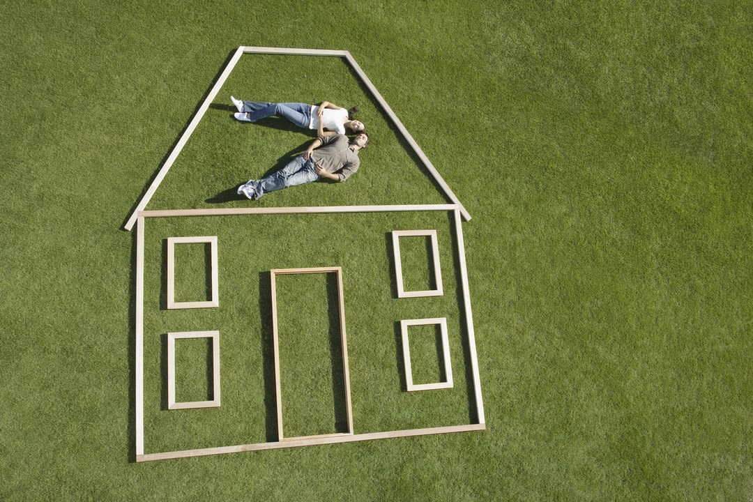 Couple laying inside house outline