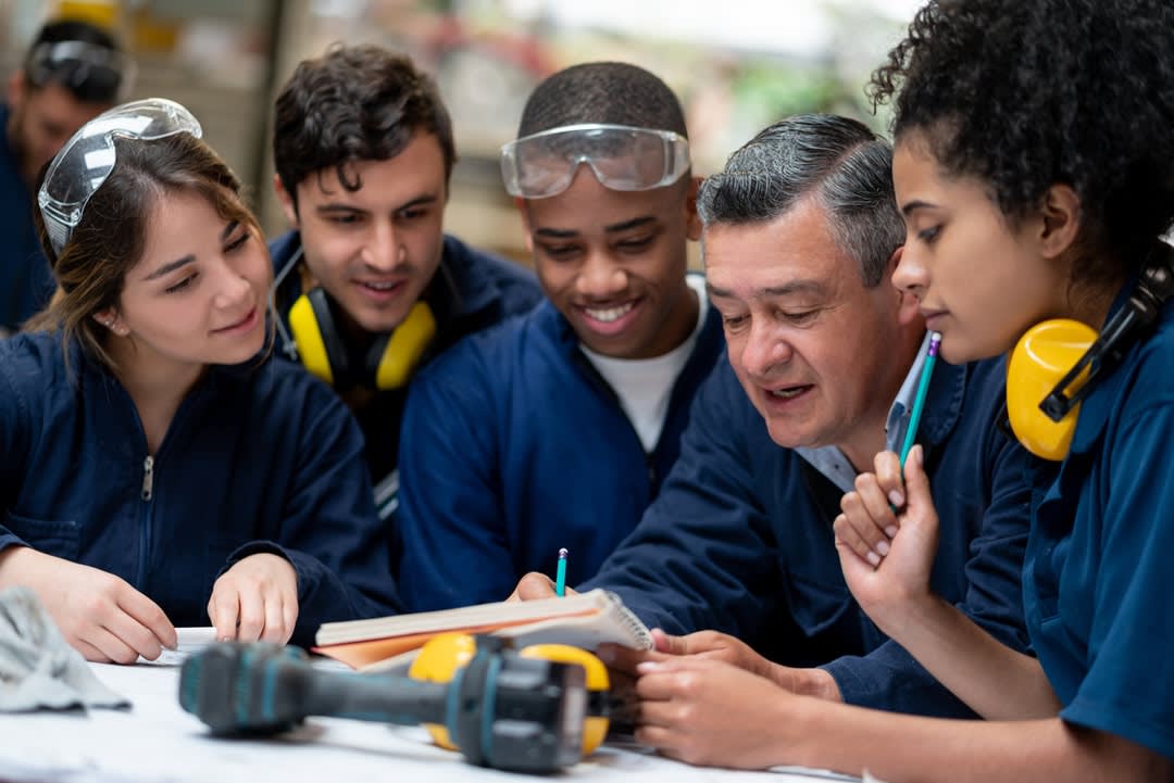 Teacher talking to a group of apprentices