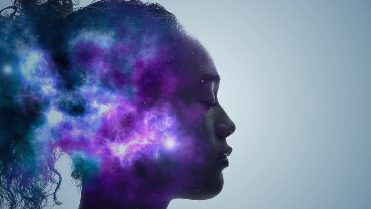 Abstract image of a woman in profile with her eyes closed, and coloured clouds in her head