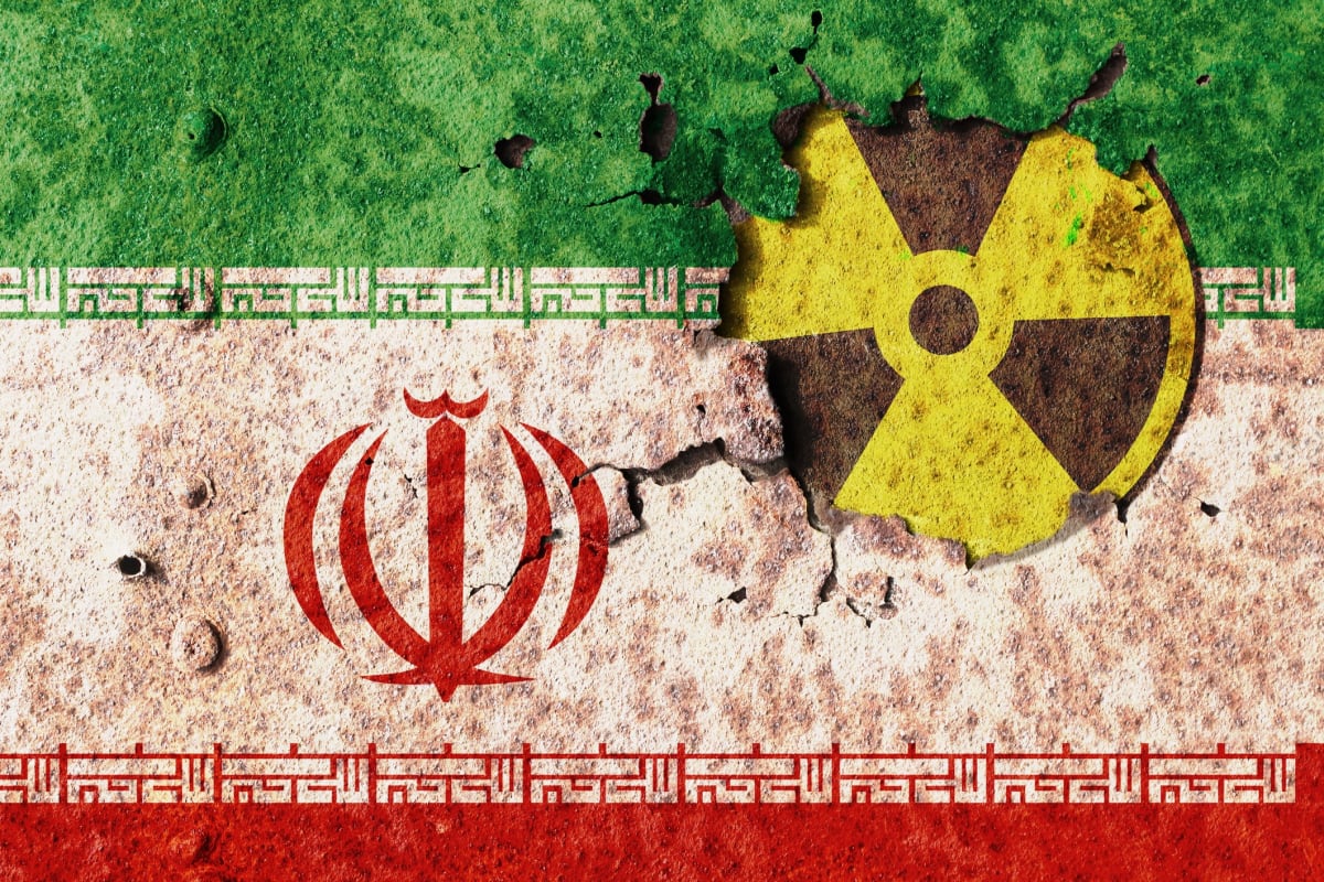  Iran flag on metal wall. Conflict of atomic technology