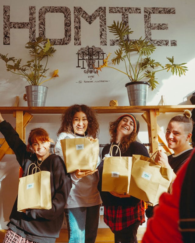 Shoppers in HoMie clothes store with their purchases