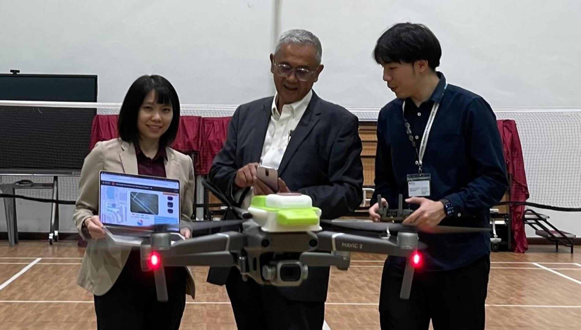 People in a gym with a drone