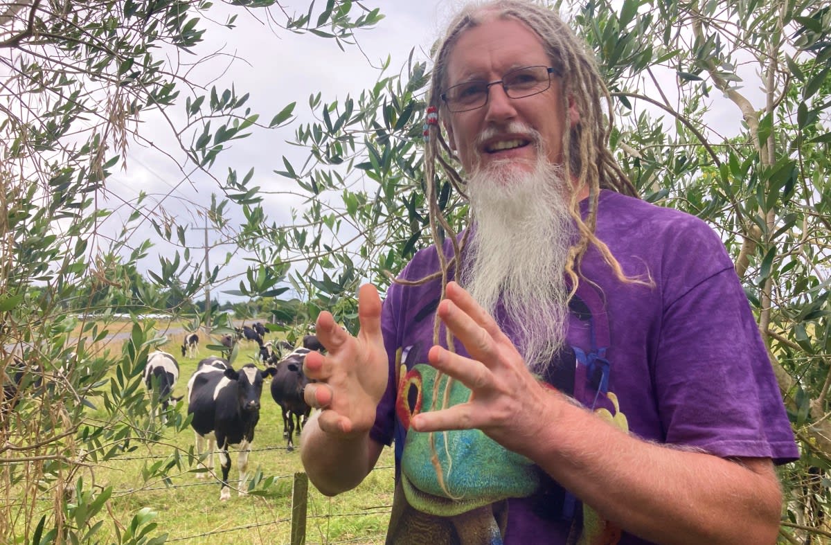 On the boundary of his orchard, David Whyte sees both the benefits of increased development and the adverse impact on their small Ohinewai farming community. Photo: Jonathan Milne