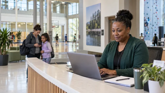 An administrator at a community center welcome desk