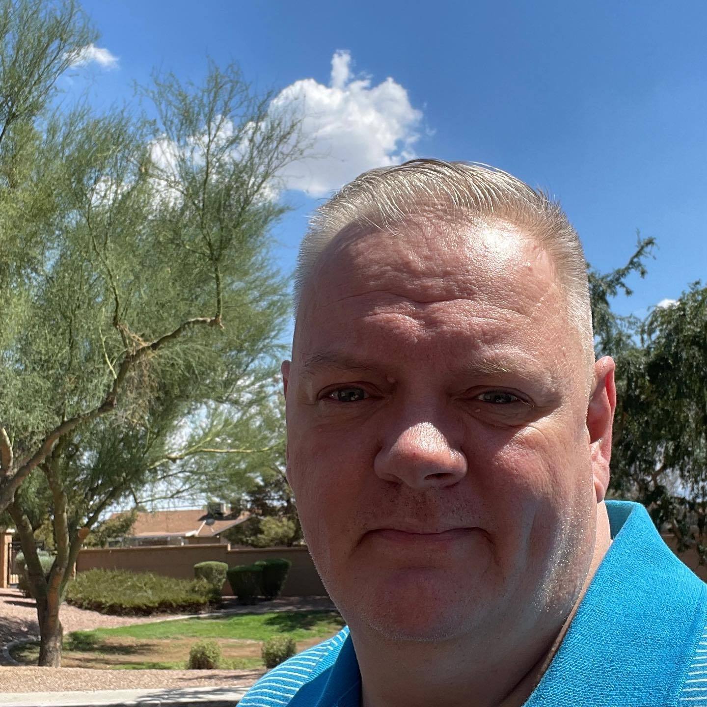 Todd standing outside in Arizona ona sunny day.