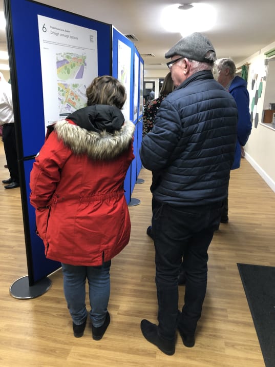 Photo of two people looking at the engagement material in round one