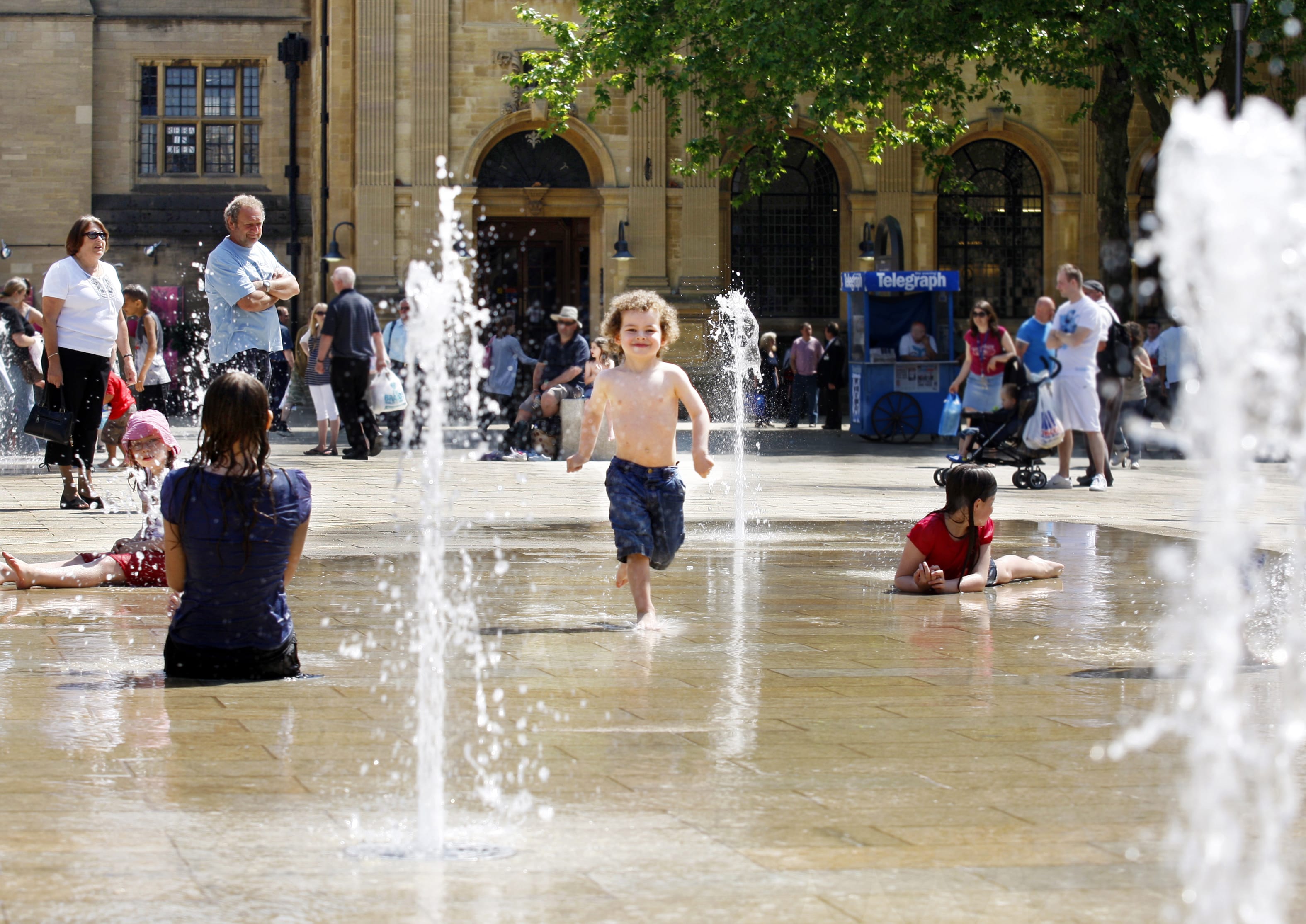 Child running through a water feature