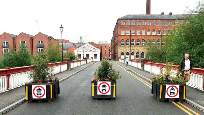 a road with signs on it and buildings in the back