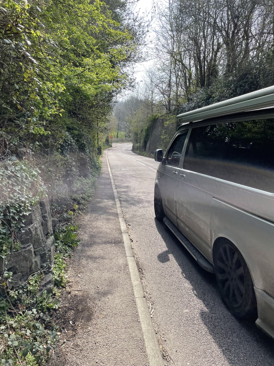 Narrow pavement with passing vehicle