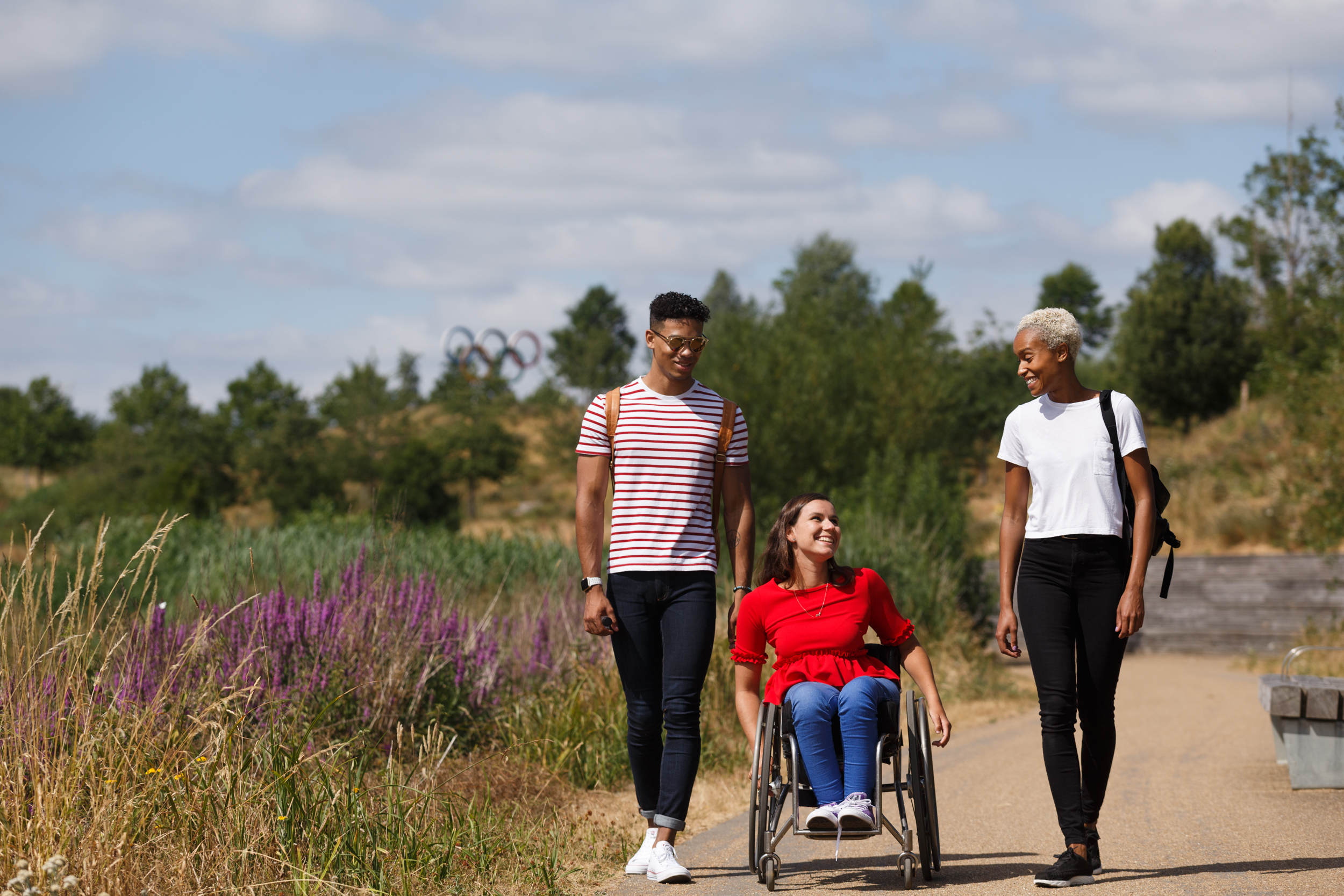 People walking with wheelchair user on path