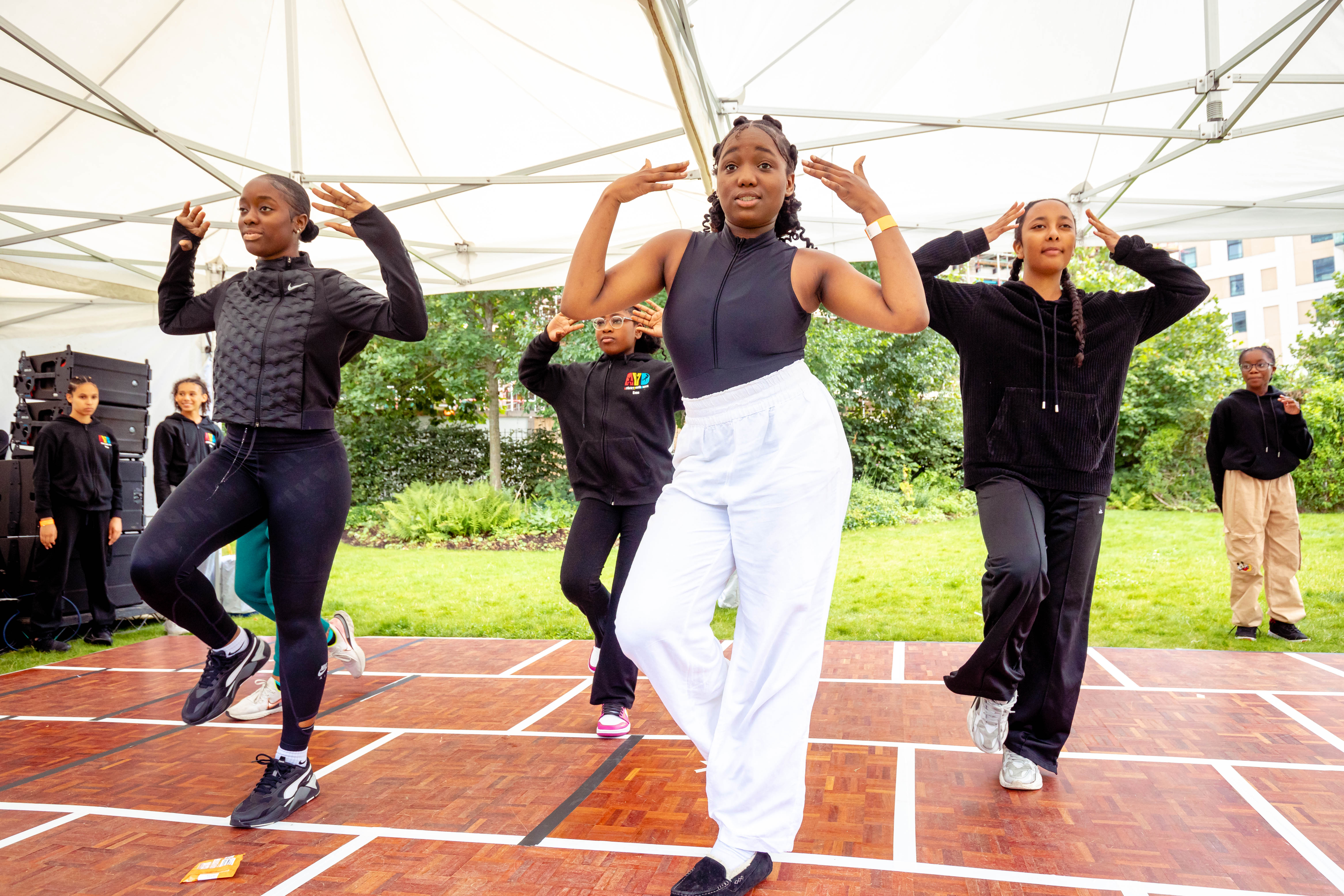 Teenage girls dancing together