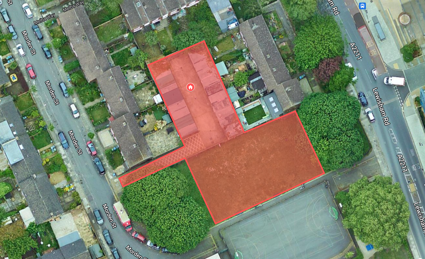 An aerial photo map showing the site to be developed outlined in red. It comprises the garages between Morden Street and Lewisham Road, with some of the green space to the south between the two trees.