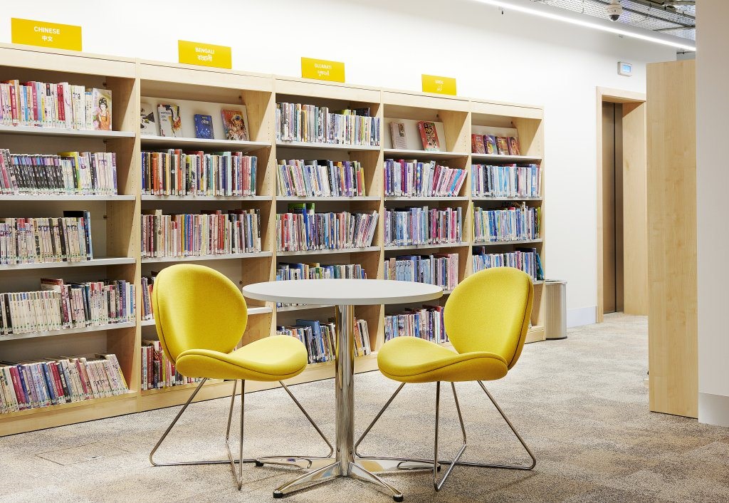 Image of two yellow chairs around a table in a library