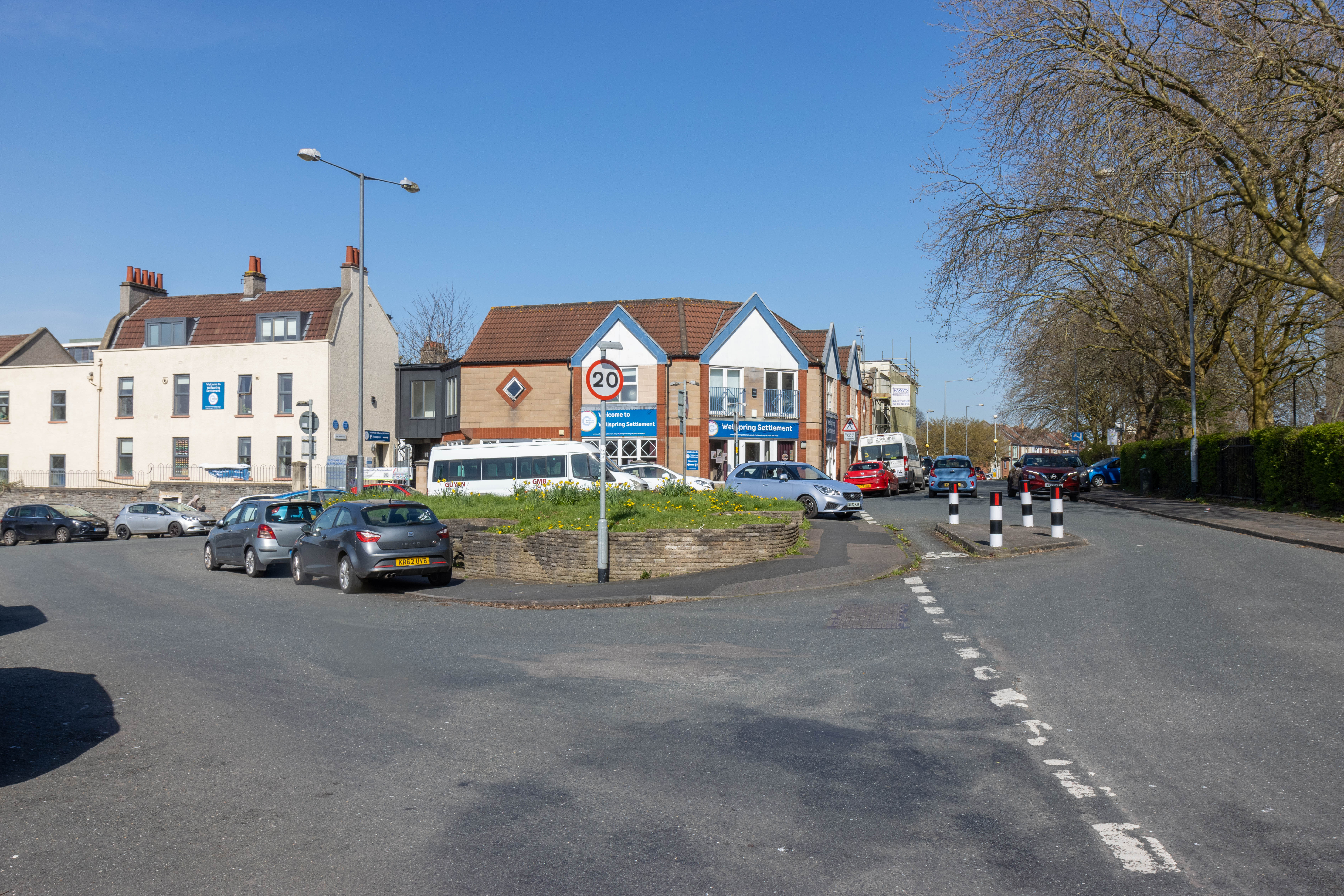 Cars parked on footways around the central green area adjacent to Barton Hill Community centre.