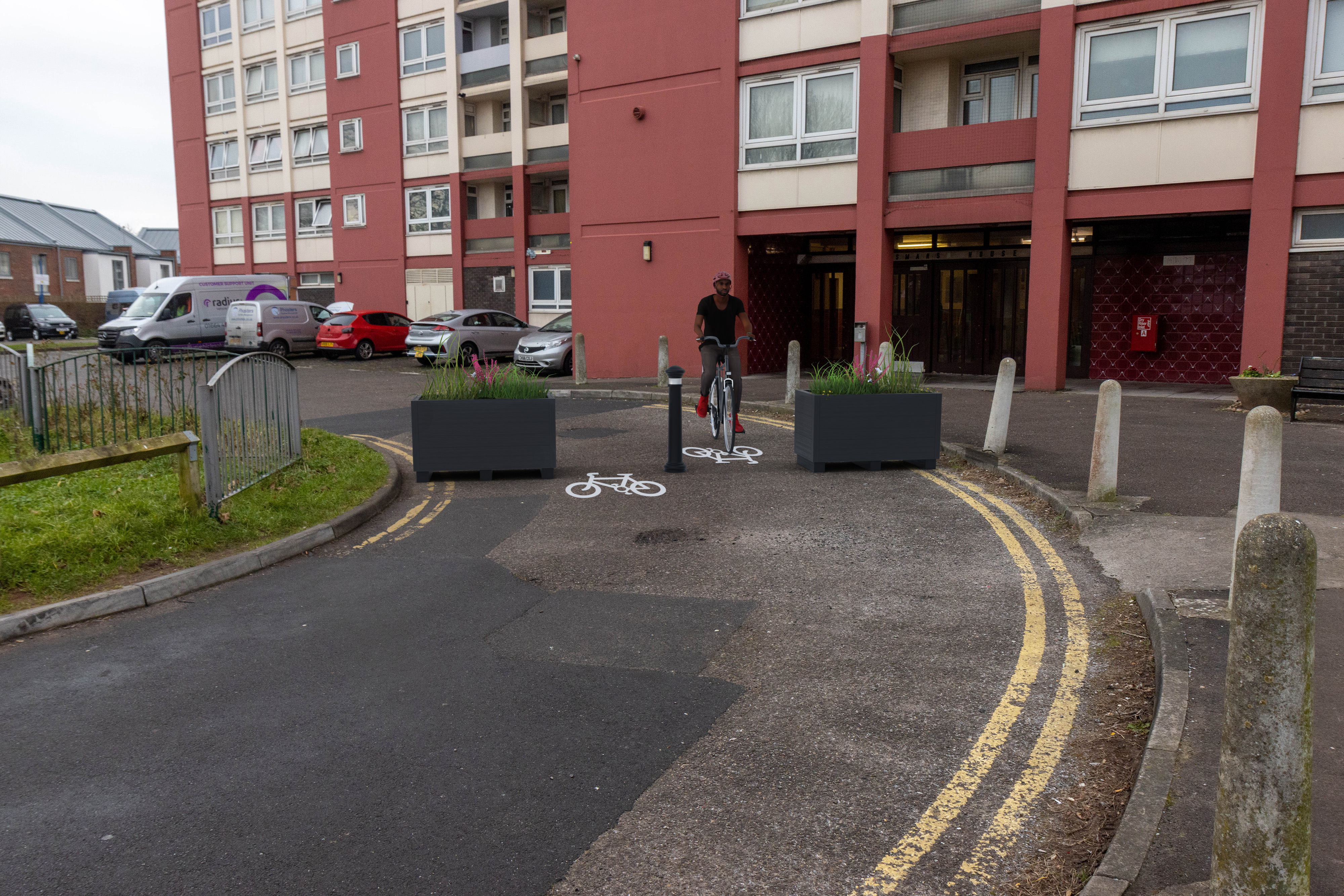 Planters and bollards to stop vehicles passing through the pedestrian space. Cycle symbols to show where cycles will pass. 