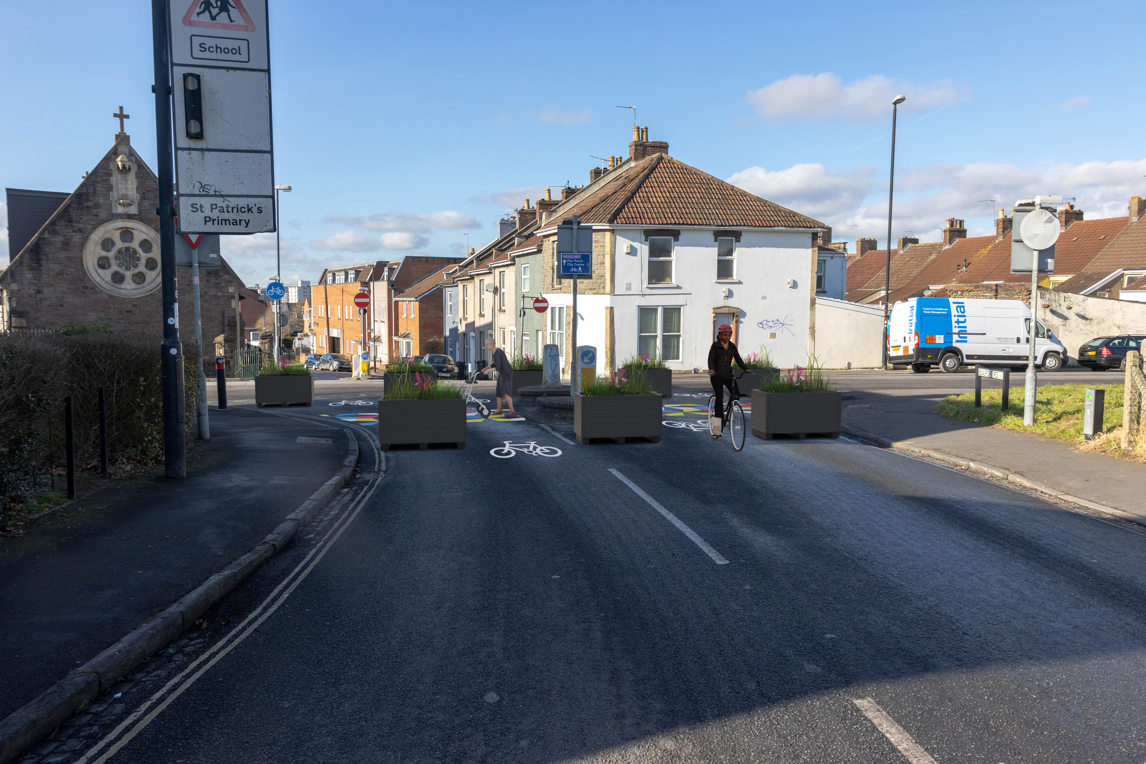 Planters used to stop vehicles from entering the pedestrianised area. Cycle symbols on the floor to show cycles will pass. Colourful artwork on the floor to highlight pedestrian area. 