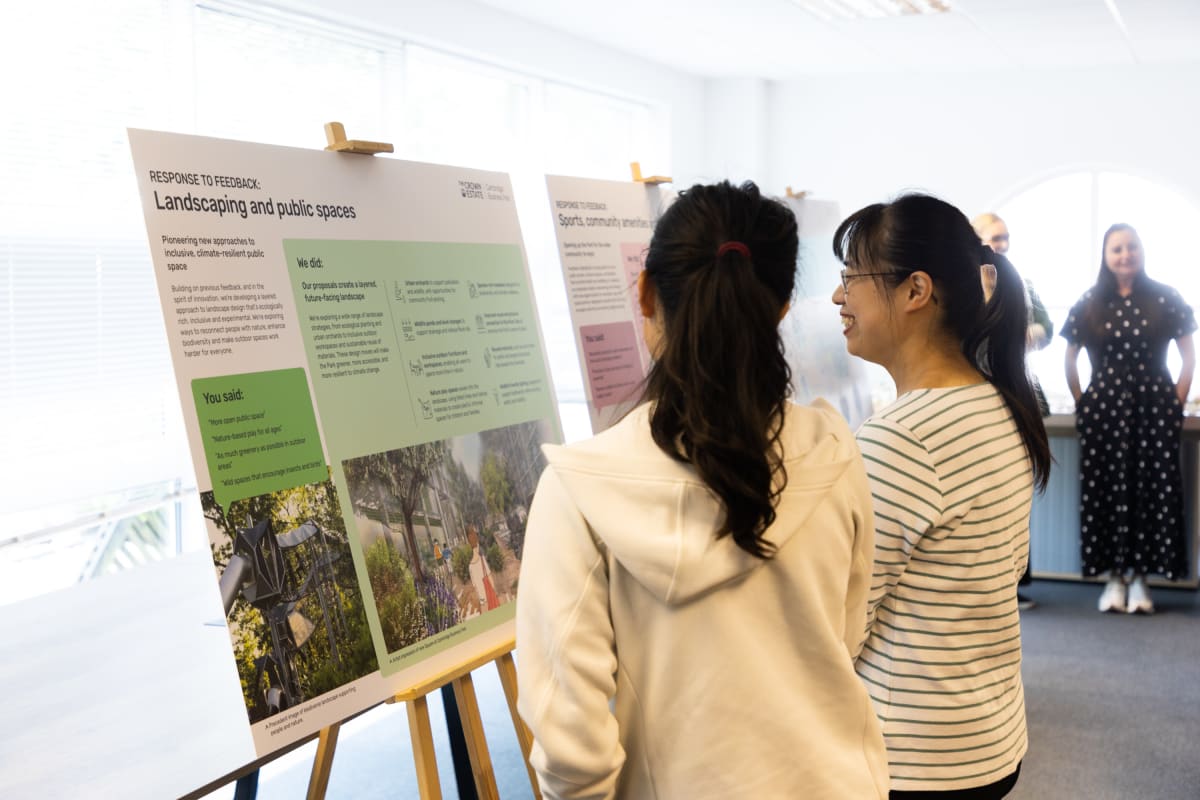 Photo of two people viewing the exhibition boards on display