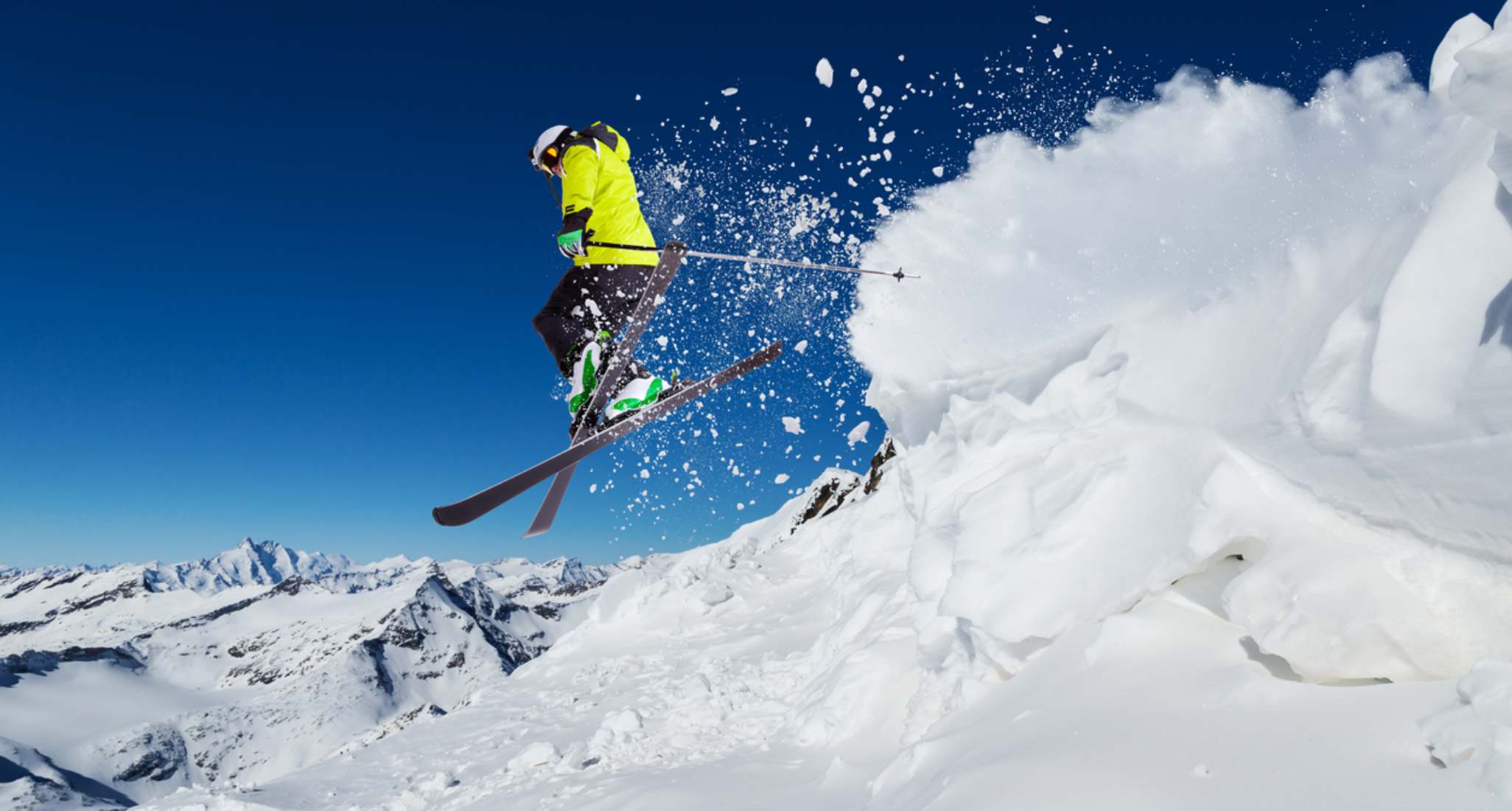 A man skiing over a jump.