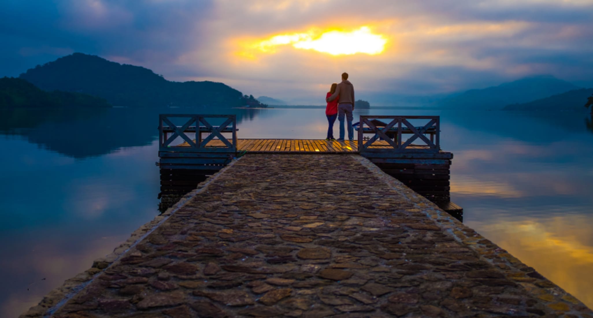Happy couple on a jetty after couples therapy