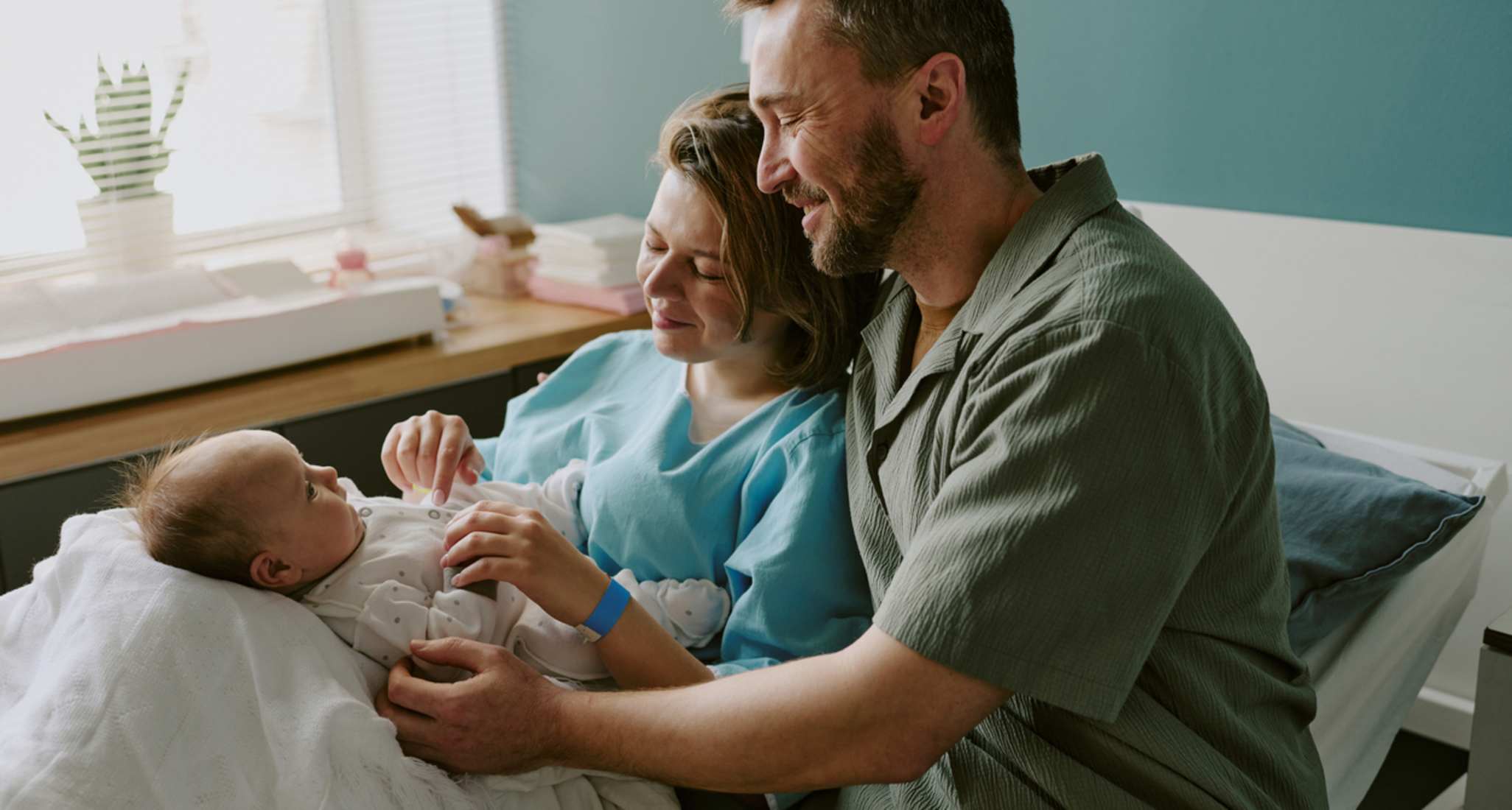 A newborn baby sleeping on the father’s chest.