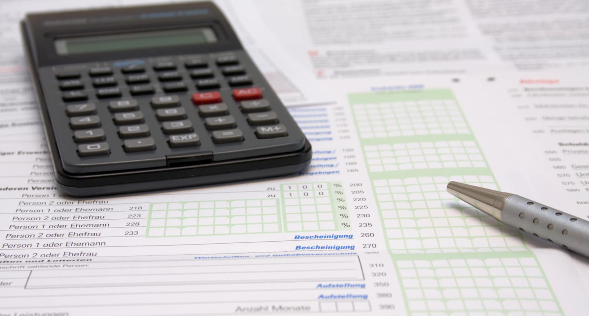 A calculator and a pen on tax declaration forms.