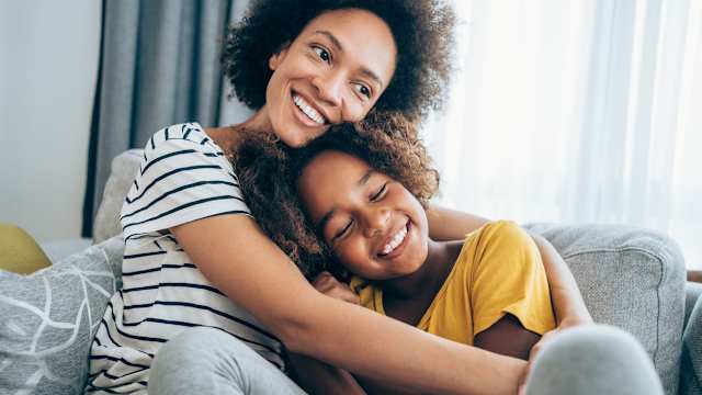 Mother sits with daughter in a rented apartment.