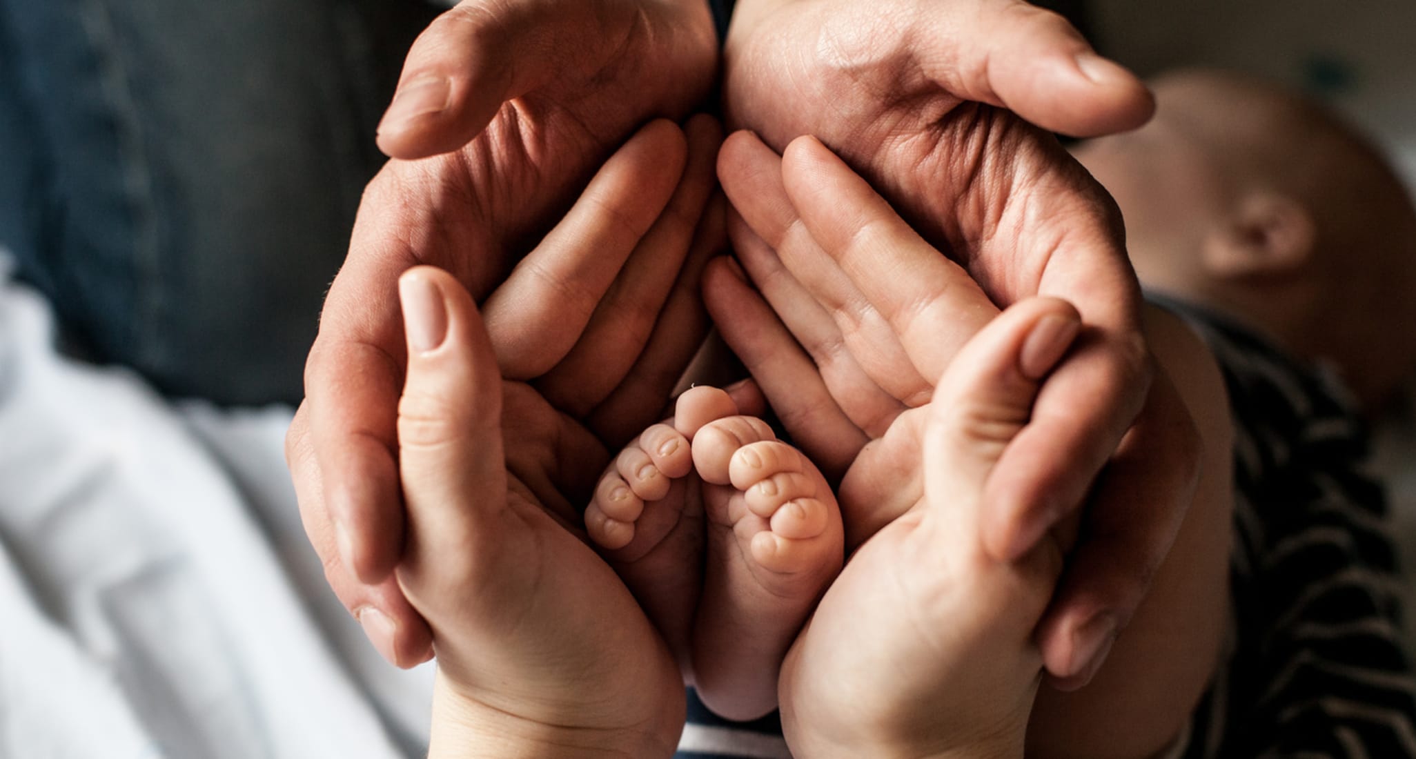 A father holds hands with his children.