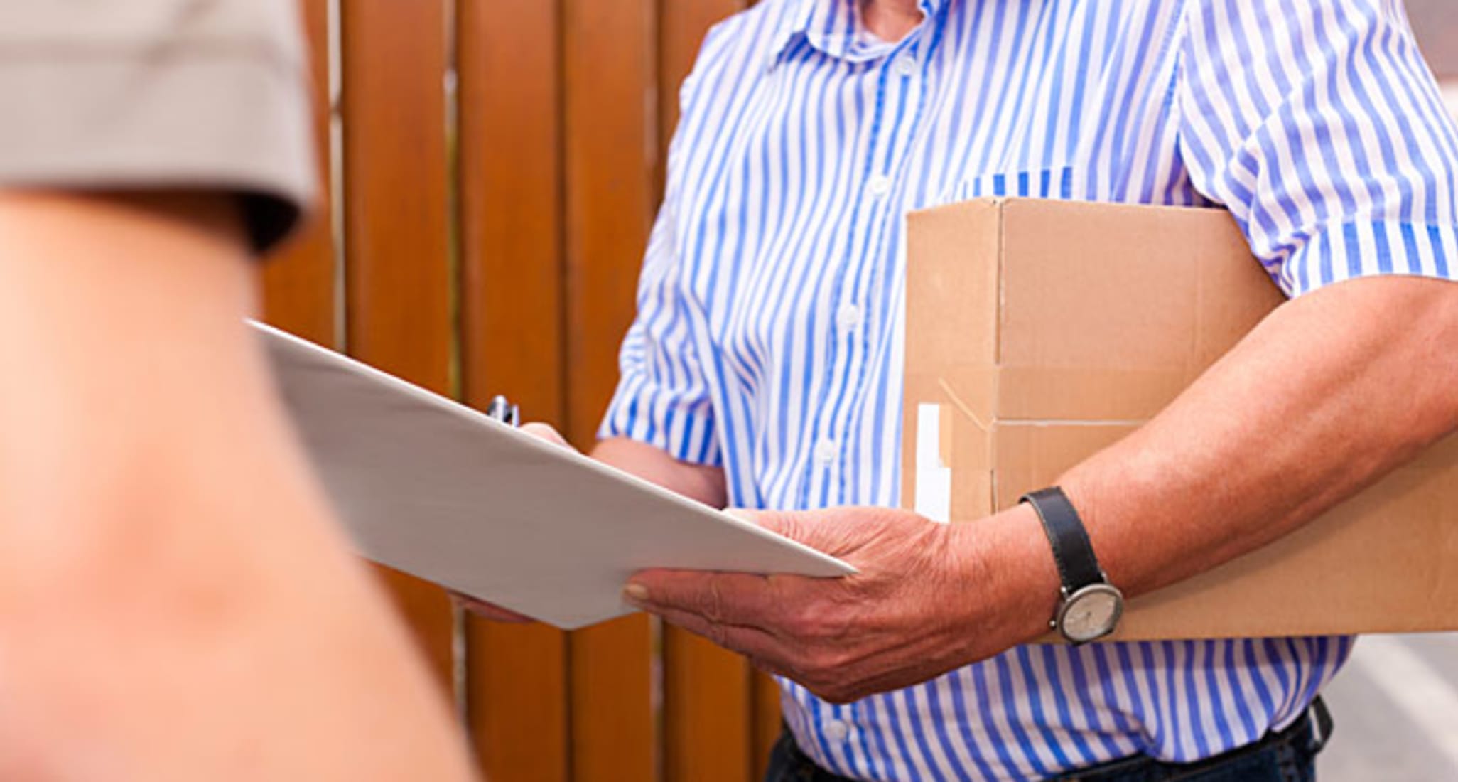 A man is holding a parcel.