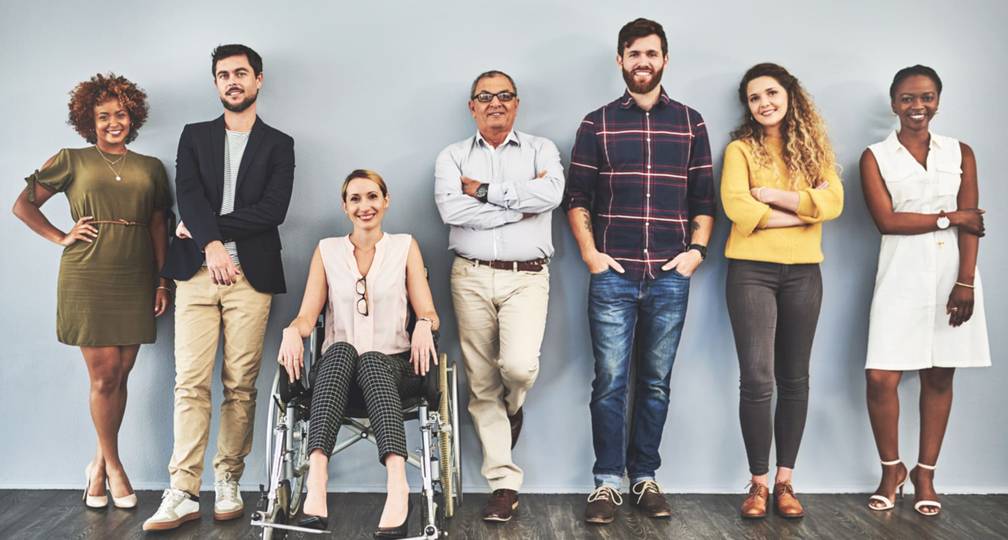 People of different age groups standing next to each other in a row.