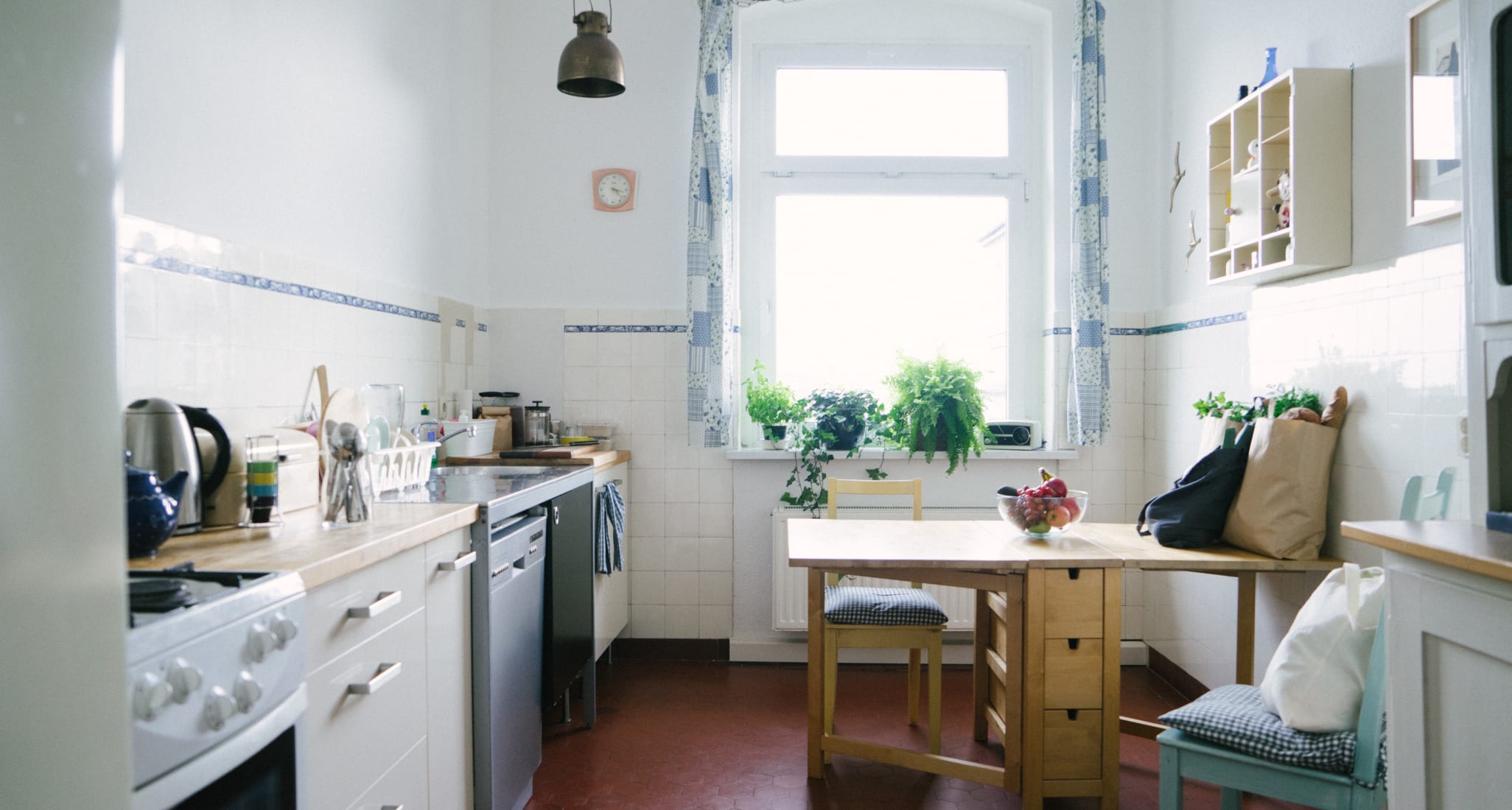 Small bright kitchen with a wooden table.