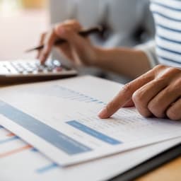 A woman calculates property transfer tax.