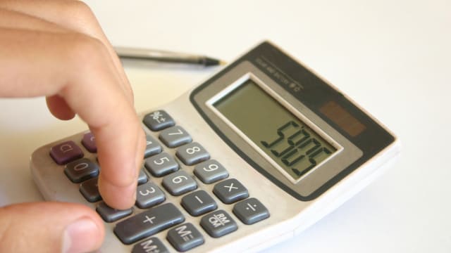 A close-up of someone using a calculator to make calculations.