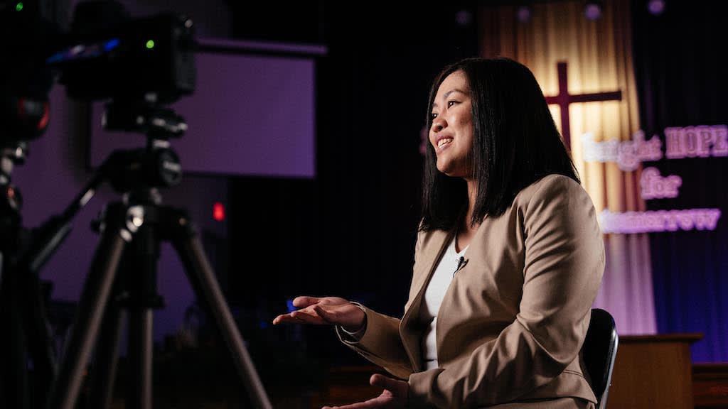Ria speaking to camera.