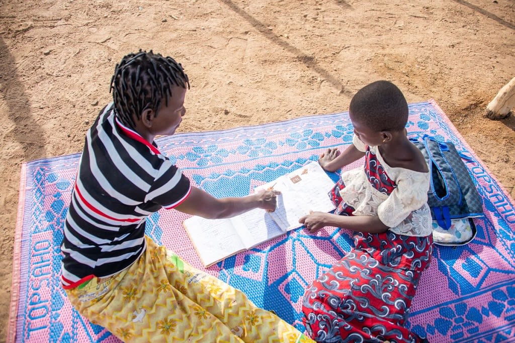Mother and daughter reading outside