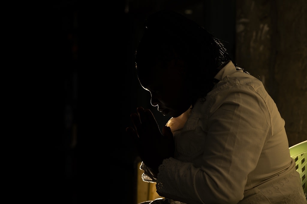 Woman sitting in the dark