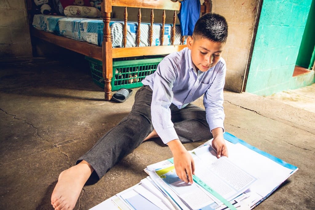 Boy reading on floor