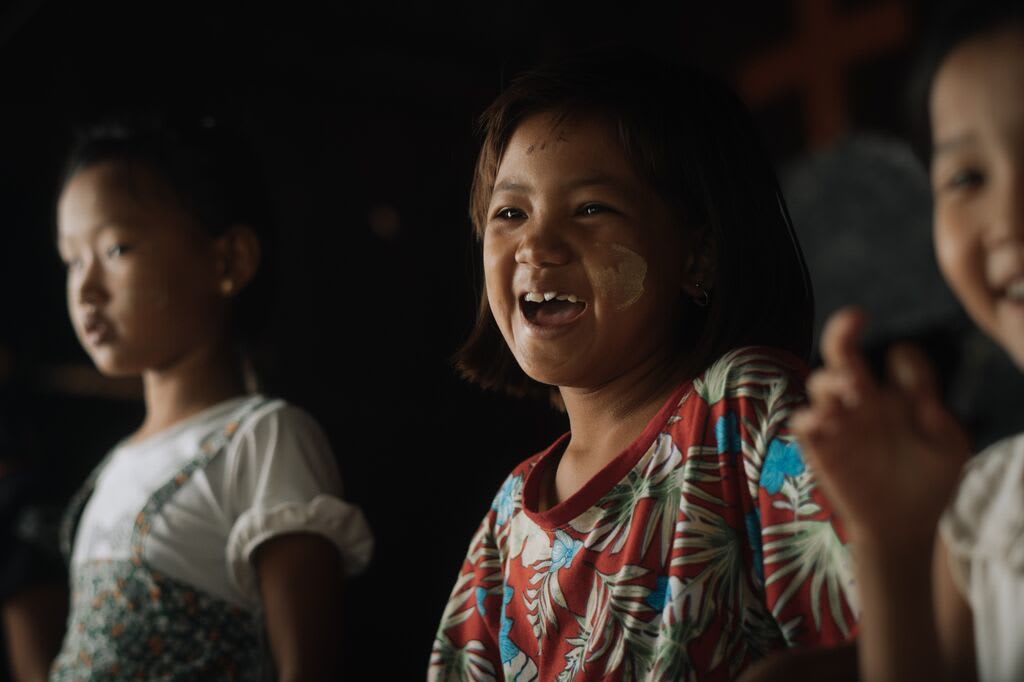 Children laughing and singing together at their Compassion centre.