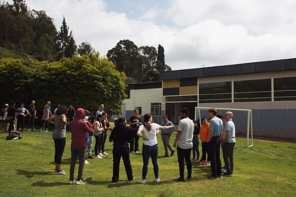 A group standing in a football field at a Compassion centre.