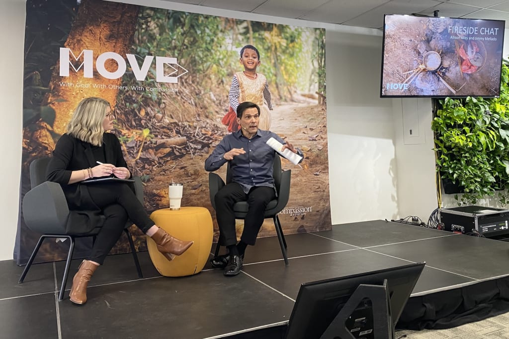 Allison Alley and Jimmy Mellado are sitting on a platform in grey chairs engaging in a "fireside chat" presentation.