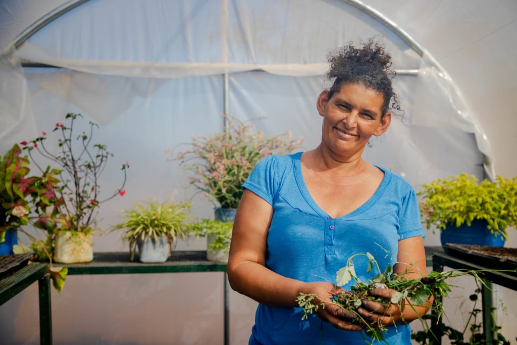 Yuri, mother of Yeri and Abner who both attend Center Emmanuel, inside of her greenhouse.