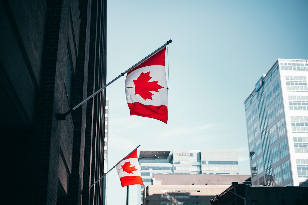 A building with Canadian flags hanging on it.