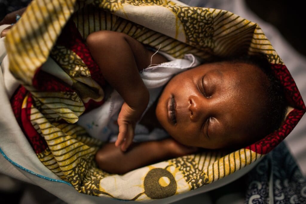 New born baby sleeps in a cozy blanket