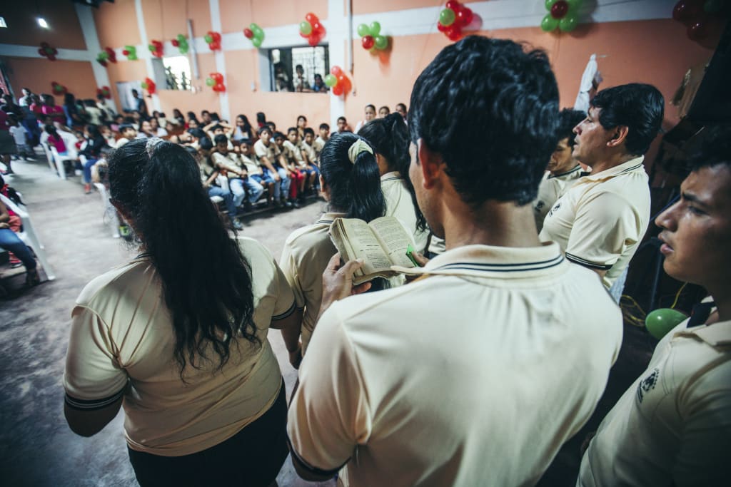 A group of staff sing as a choir at the party.