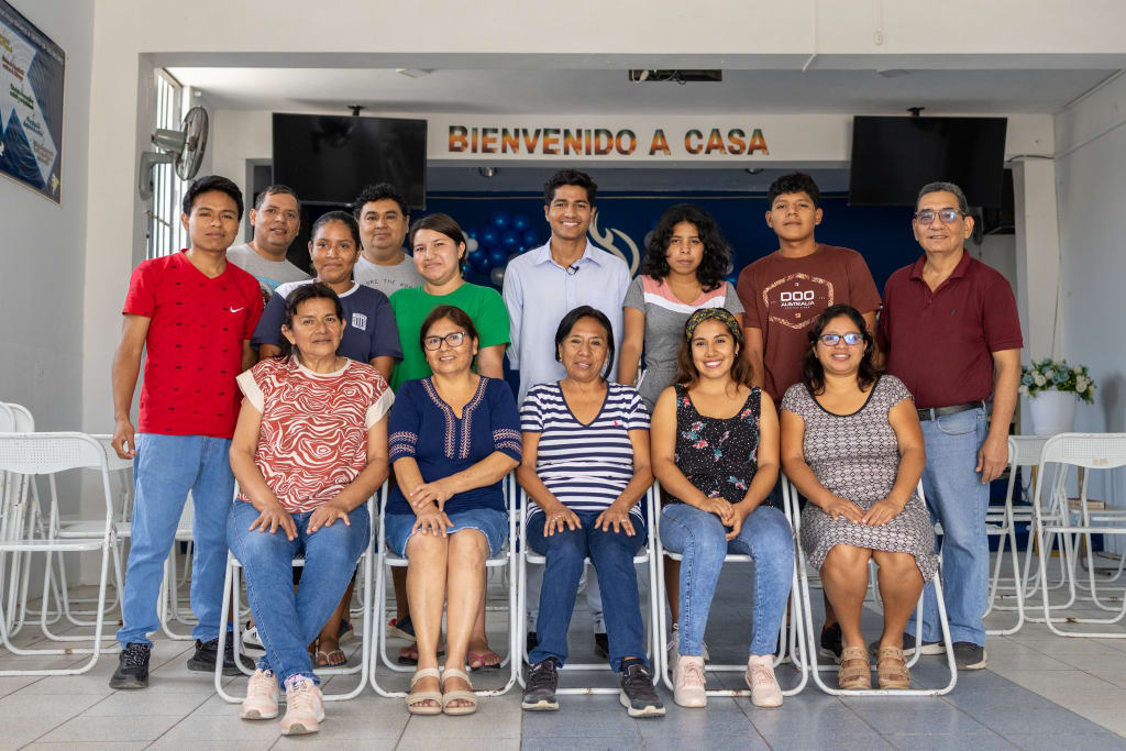 A group of youth and adults stand together for a photo.