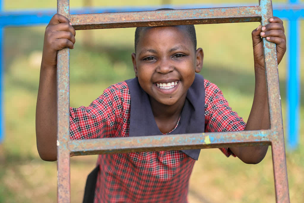 Patience gives a big smile while holding onto a ladder.
