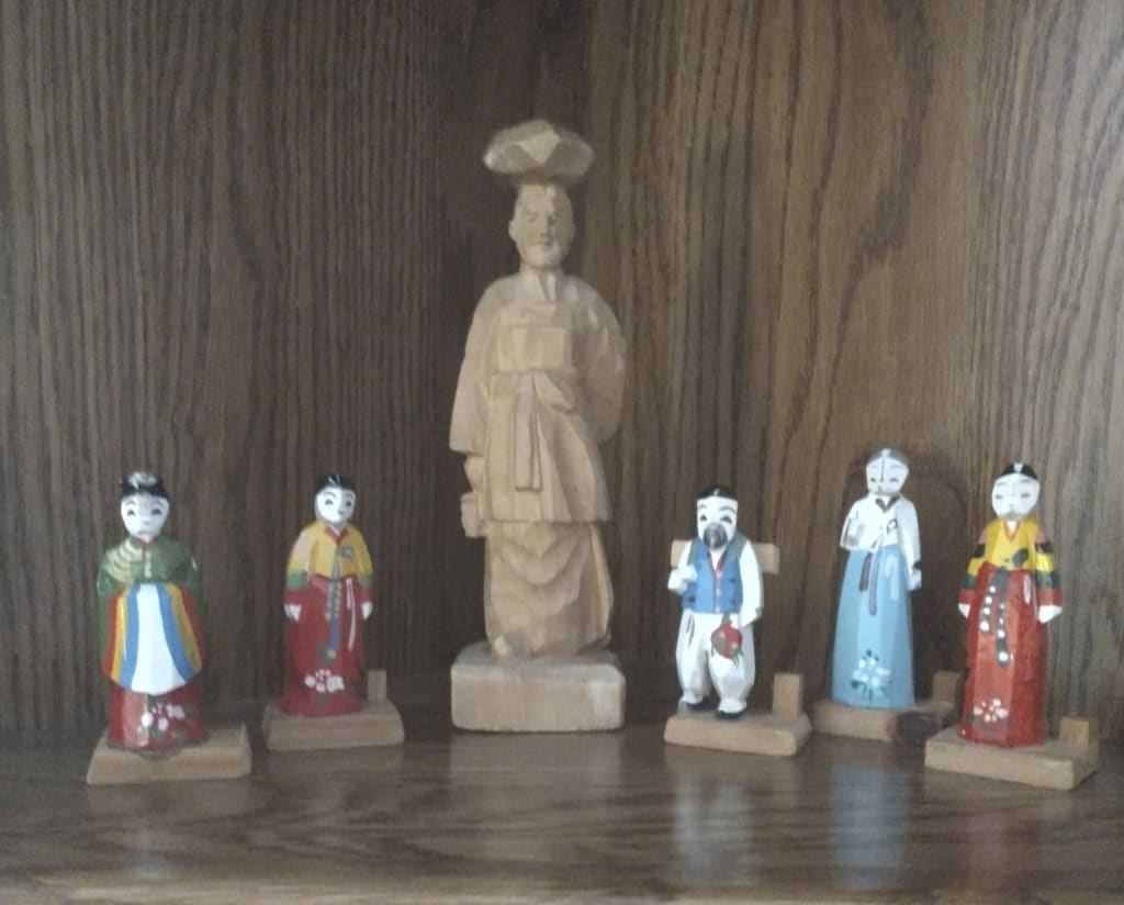 Figures of people on a table.