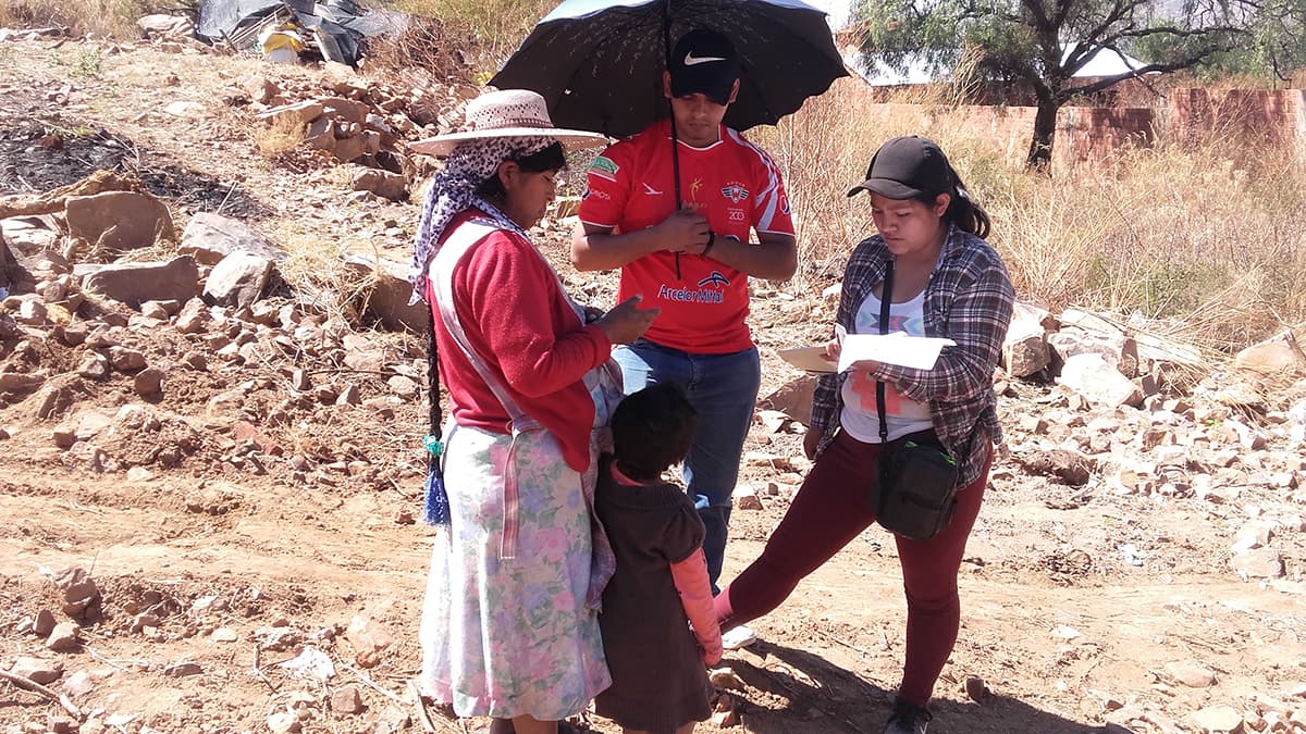 A member of the church stands and talks with different members of the community.
