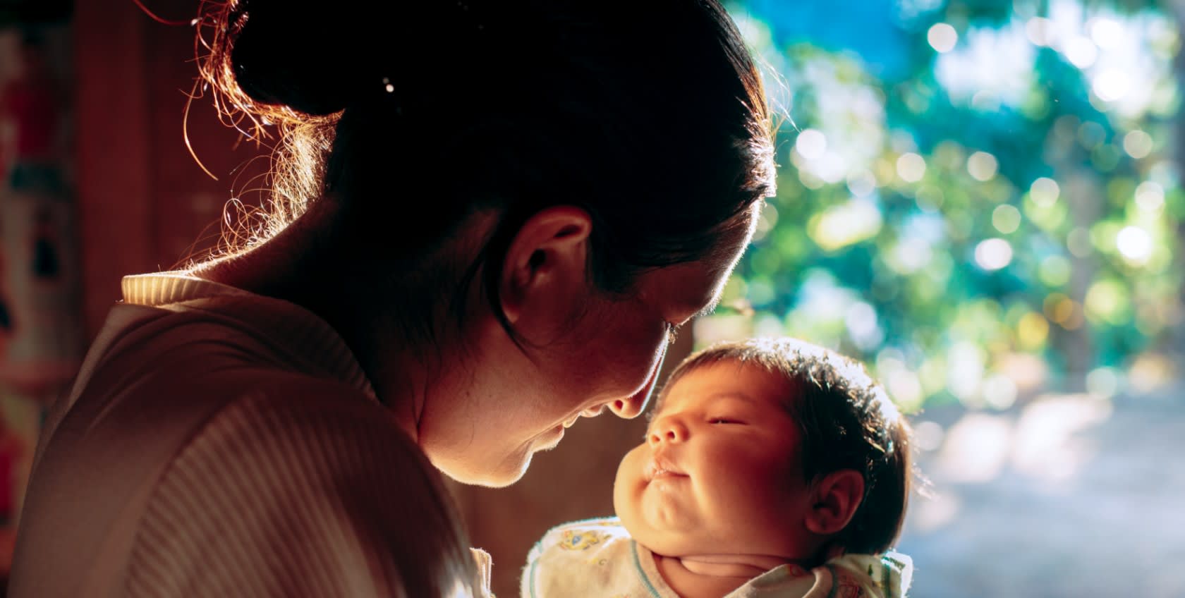 A mum holding her baby near