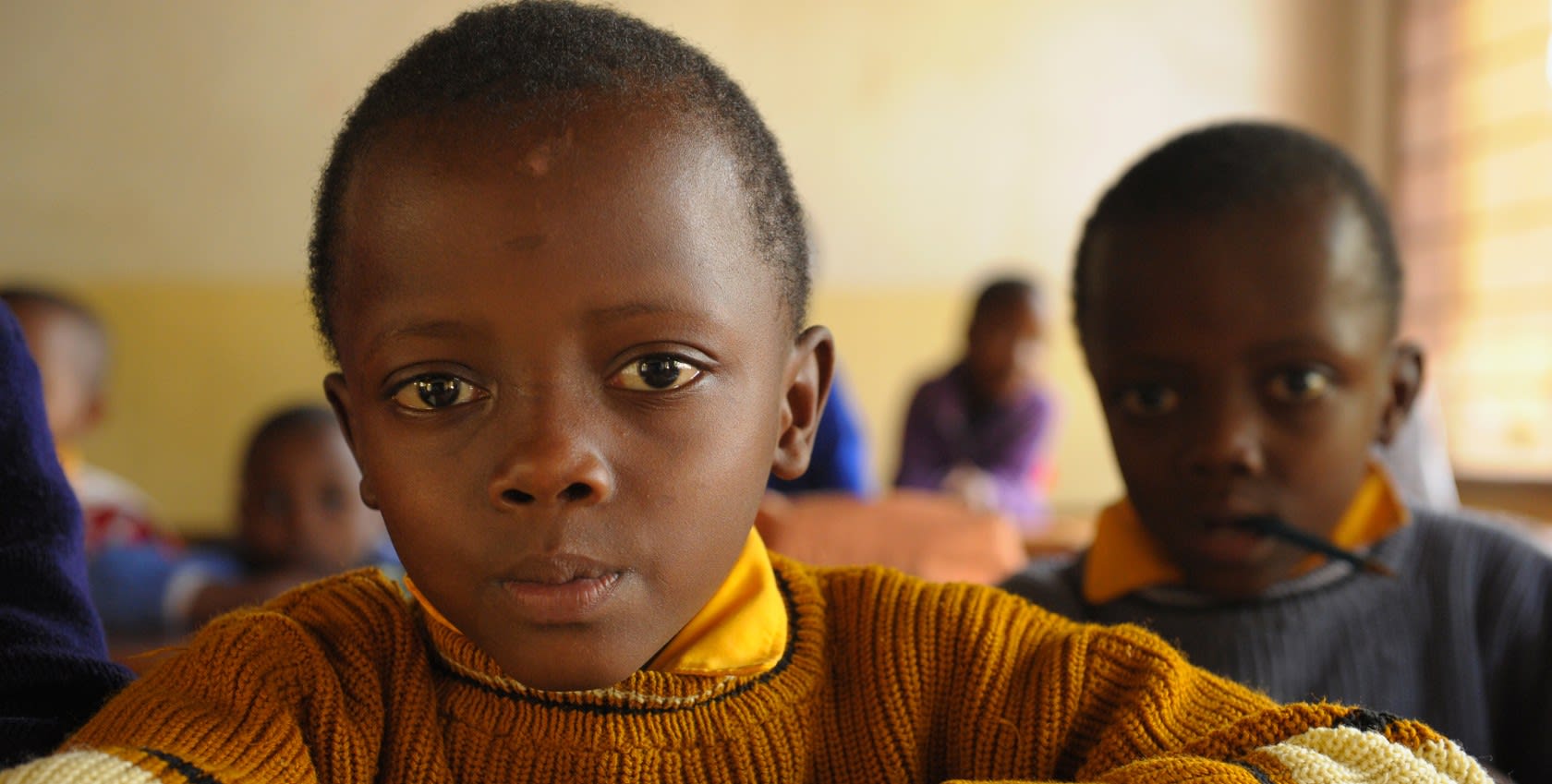 Two children in a classroom learning